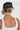 A woman wearing camouflage pants, a navy blue cap with a colorful butterfly embroidered patch and a smoky marbled beaded necklace with matte black beads and an oversized black fringe pendant  that gives  movement to the special vintage piece-Vintage_Beaded_Fringe_Pendant_Necklace
