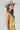 A woman wearing a  gold lace-trimmed flowy camisole top with feminine sholder ties paired with medium wash blue jeans with a relaxed wide-leg silhouette, brown boots, and a stone cowboy hat, offers the perfect blend of comfort-Medium_Wash_Cuffed_Wide_Leg_Jeans-FleaStyle