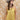 A woman wearing a  gold lace-trimmed flowy camisole top with feminine sholder ties paired with medium wash blue jeans with a relaxed wide-leg silhouette, brown boots, and a stone cowboy hat, offers the perfect blend of comfort-Medium_Wash_Cuffed_Wide_Leg_Jeans-FleaStyle
