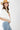 Woman wearing a white Cowboy-Poster-Graphic-T-Shirt-White, blue jeans, and a straw hat-Fleastyle