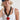 A woman wearing a navy blue trucker-style cap with a colorful butterfly patch on the front, and a chunky black sculptural link necklace finished with an oversized red heart pendant -Vintage_Resin_Heart_Link_Necklace-FleaStyle
