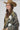 A woman wearing a western-style camo quilted jacket with white embroidered paisley patches, a graphic tee,  relaxed wide-leg silhouetted jean,  brown boots and camel cowboy hat, offers the perfect blend of stylized comfort-Camo_Quilted_Jacket_with_Paisley_Patches-FleaStyle