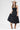 A woman wearing a black tiered strapless midi dress with a smocked bodice, paired with a beige flat-brim hat, turquoise necklace, and brown cowboy boots for a everyday casual elegance --Strapless_Mixed_Media_Midi_Dress_-_Black-FleaStyle