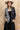 A woman wearing a beige flat-brim hat, a gray pinstripe colorbok asymmetrical plaid blazer over a black strapless tiered midi dress, a turquoise statement necklace and brown cowboy boots offers a structured but relaxed  look--Color_Block_Contrast_Blazer-FleaStyle
