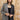 A woman wearing a beige flat-brim hat, a gray pinstripe colorbok asymmetrical plaid blazer over a black strapless tiered midi dress, a turquoise statement necklace and brown cowboy boots offers a structured but relaxed  look--Color_Block_Contrast_Blazer-FleaStyle