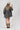 A woman wearing a beige and black leopard-print oversized denim jacket paired with a cream-colored shift dress, a beige flat brim hat, dark beaded necklace  and cowboy boots for a fun on the go look-Oversized_Leopard_Denim_Jacket-FleaStyle