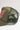 An olive green trucker hat with a mesh back, featuring an embroidered butterfly patch on the front panel and a  vintage gold-toned butterfly shaped stick pin  used to decorate cowboy hats, flat brim hats and trucker hats- Vintage Butterfly Tiger's Eye Stone Stick Pin