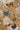 A styled flat-lay of several butterfly-shaped stick pins arranged on a floral embroidered fabric used for decorating trucker hats, cowboy hats and flat brim hats-Vintage_Butterfly_Stick_Pin_-_Blue-FleaStyle