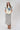 A woman modeling a cream short-sleeve top with a large blue denim star and a lace-trimmed sleeves, paired with neutral maxi skirt in a soft brown and ivory plaid, flattering bias-cut silhouette and an effortless drape-Plaid_High_Waist_Midi_Skirt_-_Khaki-FleaStyle