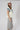 A woman modeling a cream short-sleeve top with a large blue denim star and a lace-trimmed sleeves, paired with neutral maxi skirt in a soft brown and ivory plaid, flattering bias-cut silhouette and an effortless drape-Plaid_High_Waist_Midi_Skirt_-_Khaki-FleaStyle