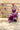 A woman wearing a  blush flat brim hat with a feather accent, a chunky stone necklace, and a burgundy lace-trim dress, posed outdoors against a colorful floral wall and barn-Stevie Wool Wide-Brim Hat - Blush-FleaStyle