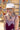 A woman wearing a burgundy maxi dress with light pink lace trim and a ivory wide-brim hat, standing outdoors in front of a yellow barn-Lace Trim Maxi Dress - Blush/Maroon