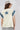 A woman wearing a cream-colored sleeveless top with a large blue star patches on front and back and  blue patterned lace appliques on the shoulders, paired with a beige cowboy hat and a Denim_Star_Patchwork_Sleeveless_T-Shirt-FleaStyle