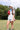 Woman holding a bag of soccer ball swith a blue bandana and white cap wearing a Striped-Front-Pocket-Drawstring-Shorts-DustyBlue-Fleastyle