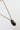 A vintage-style necklace featuring a dark, polished oval stone pendant in a bronze-toned bezel setting, suspended from a matching bronze chain-Vintage Oversized Stone Pendant Necklace-FleaStyle