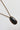 A vintage-style necklace featuring a dark, polished oval stone pendant in a bronze-toned bezel setting, suspended from a matching bronze chain-Vintage Oversized Stone Pendant Necklace-FleaStyle