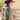 A woman wearing a western-style olive faux leather jacket covered in cream appliqué, silver-tone studs and turquoise-inspired details paired with  a maroon cowboy hat, and brown boots and lace tired dress-Turquoise Studded Leather Jacket - Olive-FleaStyle-