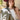 A woman wearing a maroon curl-brimmed cowboy hat and an ivory halter dress, posing in front of a light beige wooden barn wall-Rider_Wool_Cowboy_Hat_-_Maroon-FleaStyle.