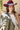 A woman wearing a maroon curl-brimmed cowboy hat and an ivory halter dress, posing in front of a light beige wooden barn wall-Rider_Wool_Cowboy_Hat_-_Maroon-FleaStyle.