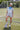 Woman with a soccer ball with a blue bandana and white cap wearing a Striped-Front-Pocket-Drawstring-Shorts-DustyBlue-Fleastyle