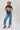 A woman wearing a cotton graphic tee featuring a lived-in charcoal wash, relaxed fit and bold 'She's From Texas Can Tell' graphic design, paired with a beige cowboy hat and jeans-She_s_From_Texas_Graphic_T-Shirt_-_Red-FleaStyle