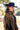 A woman wearing a black cowboy hat, an ornate long beaded black and gold fringe caplet over a black lace tunic standing in a rustic barn-Beaded_Fringe_Capelet_-_Gold-FleaStyle