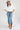 A woman wearing a white puff-sleeve bubble hem , button-up blouse, blue jeans, and a stone cowboy hat-Bubble_Sleeve_Button_Down_Top_-_White-FleaStyle
