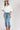 A woman wearing a white puff-sleeve bubble hem , button-up blouse, blue jeans, and a stone cowboy hat-Bubble_Sleeve_Button_Down_Top_-_White-FleaStyle