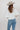 A woman wearing a white puff-sleeve bubble hem , button-up blouse, blue jeans, and a stone cowboy hat-Bubble_Sleeve_Button_Down_Top_-_White-FleaStyle