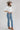 A woman wearing a white puff-sleeve bubble hem , button-up blouse, blue jeans, and a stone cowboy hat-Bubble_Sleeve_Button_Down_Top_-_White-FleaStyle