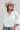 A woman wearing a white puff-sleeve bubble hem , button-up blouse, blue jeans, and a stone cowboy hat-Bubble_Sleeve_Button_Down_Top_-_White-FleaStyle