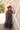 A woman wearing a red curl brim cowboy hat and a sheer leopard-print dress with a high ruffled collar and ruffled hem paired with cowboy boots in a field-Rider_Wool_Cowboy_Hat_-_Red-FleaStyle