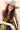 A smiling woman wearing a curl-brimmed light beige hat, a brown dress with olive green lace trim, and a chunky gold necklace, posed against ayellow bar-Jenner Cowboy Cashmere Wool Hat - Stone