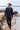 Man in a Rider Wool Cowboy Hat - Brown and dark shirt walking along a rocky shoreline-FleaStyle