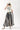 Woman wearing a 'Texas Y'All' shirt and a Stripe-Flare-Maxi-Skirt-Black_Cream-Fleastyle