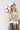 Woman wearing a 'Texas Y'all' shirt and holding a soccer ball in a striped skirt-Fleastyle