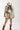 Woman wearing a beige cap, camouflage jacket, and Gingham-Bubble-Mini-Skirt-Khaki-Fleastyle