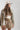 Woman wearing a beige cap, camouflage jacket, and Gingham-Bubble-Mini-Skirt-Khaki-Fleastyle