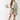 Woman wearing a Camo Ruffle Hem  Shacket with a peace symbol, plaid skirt, and cowboy boots-Fleastyle