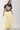 Woman wearing a Choosin_Texas-Graphic-T-Shirt-Yellow and Tiered Ruffle Polka Dot Maxi Skirt - Butter Yellow-Fleastyle