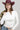 A woman wearing a classic long-sleeve tee features a flattering, fitted silhouette with an elegant boat neckline worn alone or styled as an effortless layering piece--Boat_Neck_Long_Sleeve_Top_-_Ivory-FleaStyle