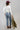 A woman wearing a classic long-sleeve tee features a flattering, fitted silhouette with an elegant boat neckline worn alone or styled as an effortless layering piece--Boat_Neck_Long_Sleeve_Top_-_Ivory-FleaStyle