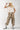 Woman wearing a beige Texas-Short-Sleeve-Ribbed-T-Shirt-Light-Khaki- white cap with a patch-Fleastyle 