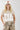 Woman wearing a beige Texas-Short-Sleeve-Ribbed-T-Shirt-Light-Khaki- white cap with a patch-Fleastyle 