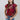 A woman wearing a maroon short-sleeve crewneck sweater with a red, orange, and white tiger print, paired with blue jeans and a rust cowboy hat-Tiger_Tapestry_Short-Sleeve_Sweater-FleaStyle