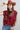A woman wearing a maroon short-sleeve crewneck sweater with a red, orange, and white tiger print, paired with blue jeans, turquoise elongated concho earrings and a rust cowboy hat-Tiger_Tapestry_Short-Sleeve_Sweater-FleaStyle