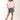Woman wearing a pink shirt, High Rise Frayed Hem A Line Denim Shorts, and cowboy boots on a white background