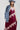 A woman wearing a  maxi dress in deep burgundy with light pink floral lace trim, styled with a dusty blue cowboy hat and holding a blue denim jacket against a plain white studio background.-Lace_Trim_Maxi_Dress_-_Blush_Maroon-FleaStyle