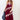 A woman wearing a  maxi dress in deep burgundy with light pink floral lace trim, styled with a dusty blue cowboy hat and holding a blue denim jacket against a plain white studio background.-Lace_Trim_Maxi_Dress_-_Blush_Maroon-FleaStyle