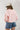 Woman wearing a baseball cap and High Rise Frayed Hem A Line Denim Shorts-Fleastyle